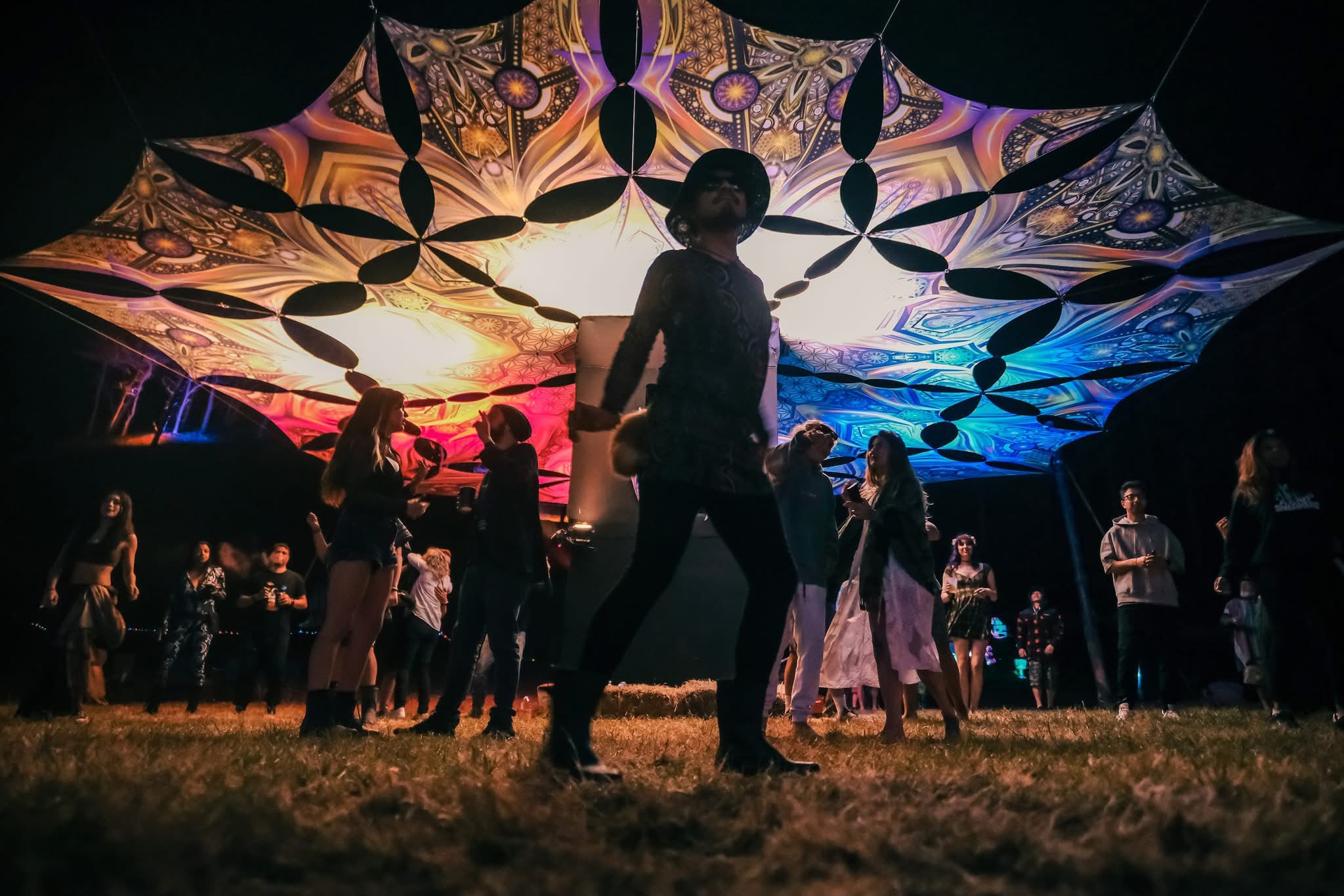 Dancing beneath a patterned canopy at night
