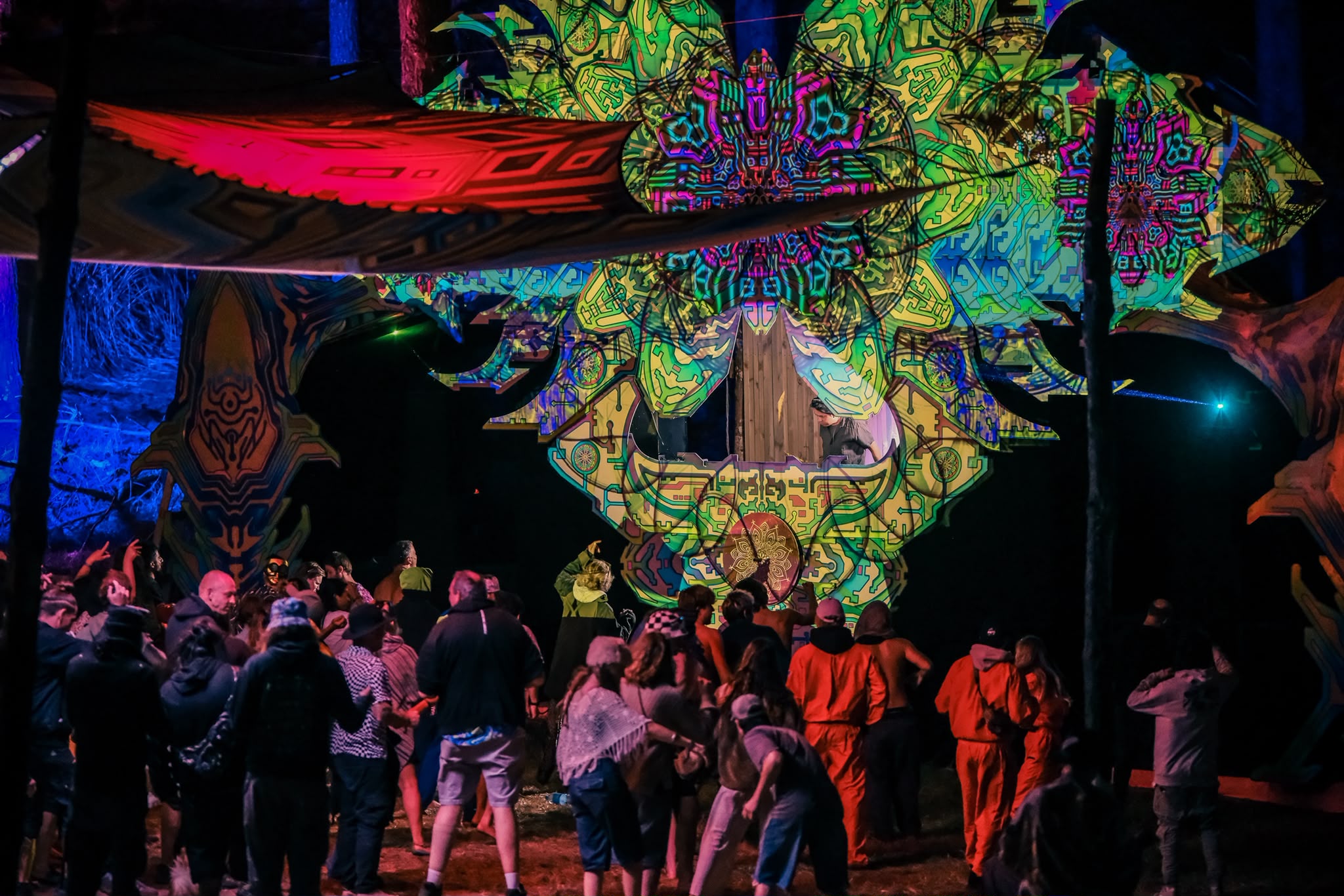 Dancers in front of a brightly illuminated stage